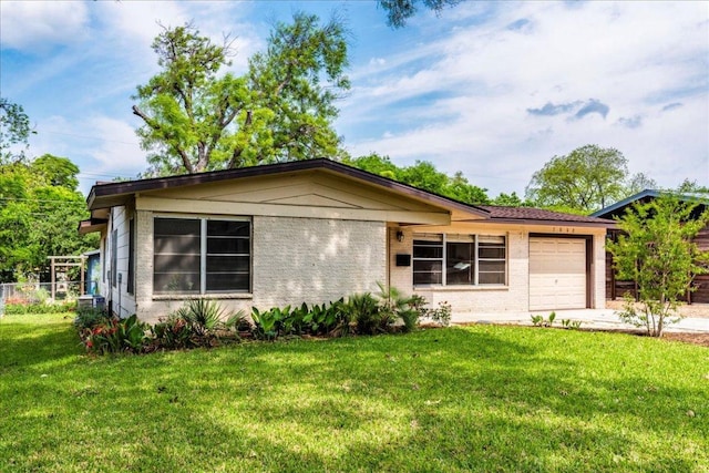 single story home featuring an attached garage, fence, driveway, and a front lawn