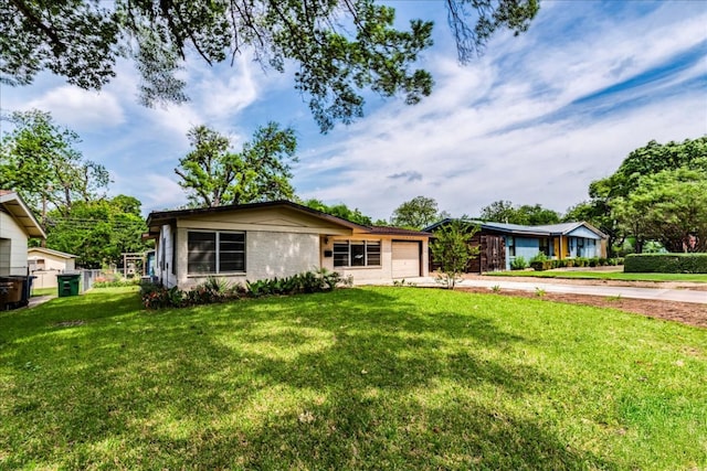 ranch-style house featuring concrete driveway, an attached garage, and a front lawn