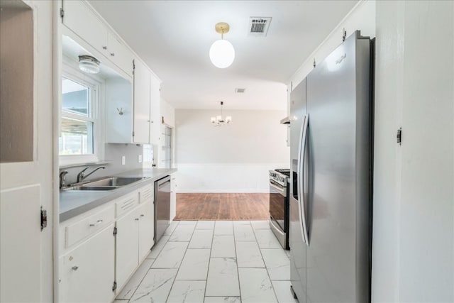 kitchen featuring marble finish floor, an inviting chandelier, visible vents, a sink, and appliances with stainless steel finishes
