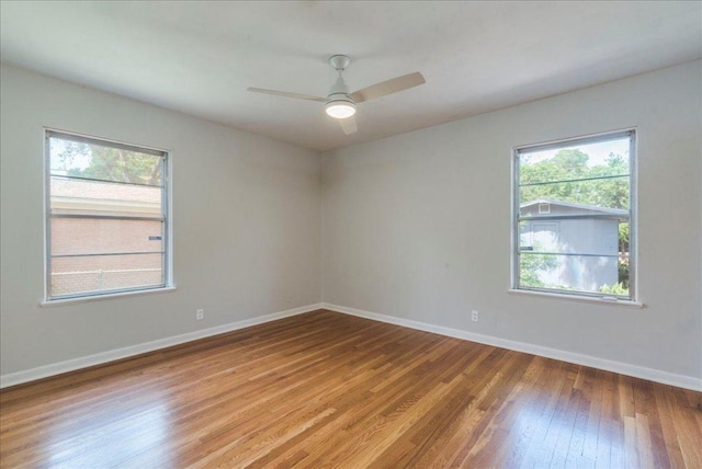 empty room with light wood-style flooring, baseboards, and ceiling fan