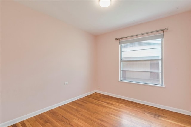 empty room featuring light wood-style flooring and baseboards