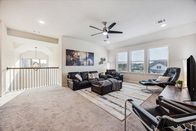 carpeted living room with recessed lighting, baseboards, visible vents, and ceiling fan with notable chandelier