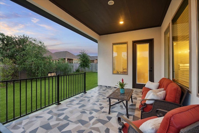 balcony at dusk featuring an outdoor living space and a patio