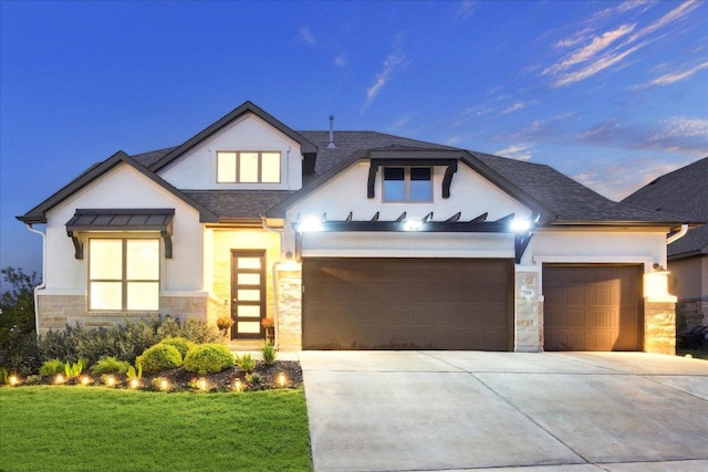 view of front facade featuring a front lawn, driveway, stone siding, a garage, and stucco siding