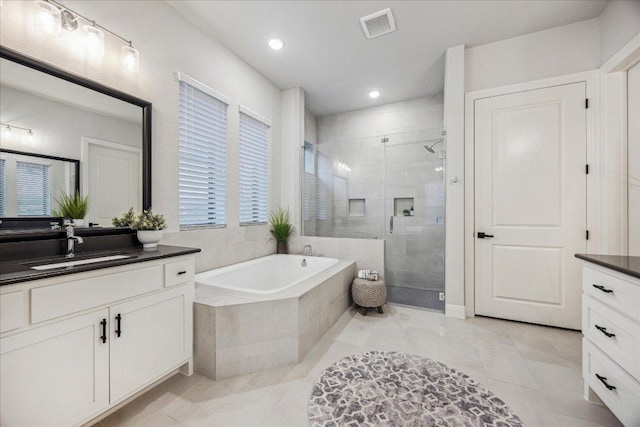 full bath featuring a bath, visible vents, tile patterned flooring, a shower stall, and vanity
