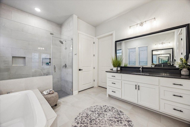 bathroom with vanity, a freestanding tub, tile patterned flooring, and a shower stall