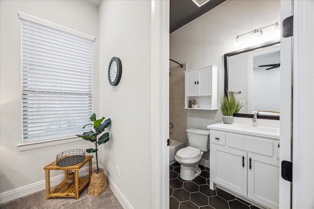 full bath with toilet, vanity, tub / shower combination, and baseboards