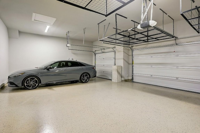 garage featuring a garage door opener and baseboards