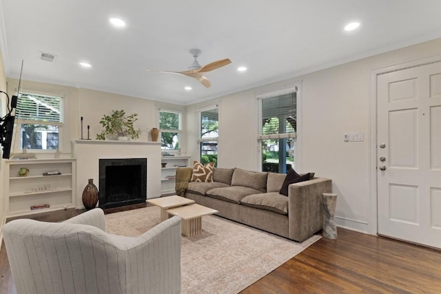 2844 Shoal Crest Ave, Austin, TX 78705 - living area with a fireplace with flush hearth, a ceiling fan, dark wood-style flooring, and plenty of natural light
