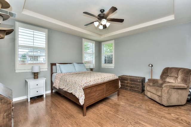 110 Chestnut Ct, Georgetown, TX 78633 - bedroom with a tray ceiling, wood finished floors, and a ceiling fan