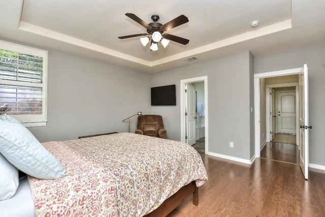 110 Chestnut Ct, Georgetown, TX 78633 - bedroom featuring a raised ceiling, dark wood finished floors, baseboards, and a ceiling fan