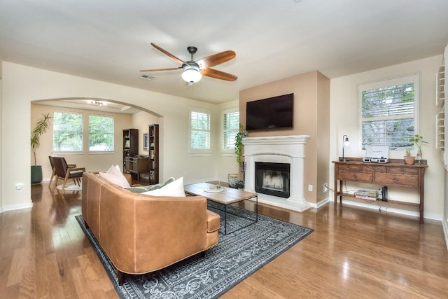 110 Chestnut Ct, Georgetown, TX 78633 - living room featuring a ceiling fan, a glass covered fireplace, wood finished floors, and plenty of natural light