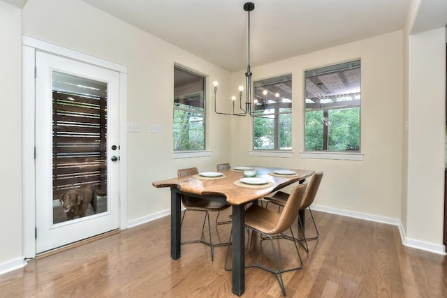 110 Chestnut Ct, Georgetown, TX 78633 - dining area featuring baseboards, wood finished floors, and a chandelier