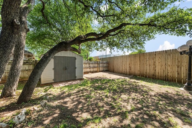fenced backyard featuring a storage unit and an outdoor structure