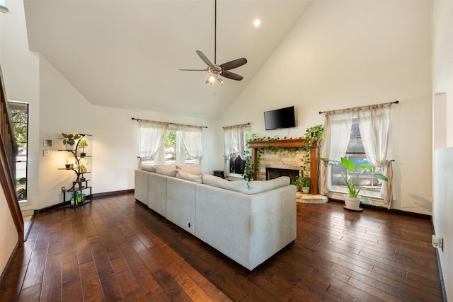 3403 NW Blvd, Georgetown, TX 78628 - living room with a ceiling fan, high vaulted ceiling, a fireplace with raised hearth, and dark wood-type flooring