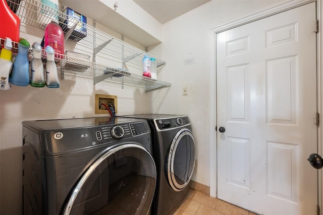 3403 NW Blvd, Georgetown, TX 78628 - laundry room with washer and clothes dryer and light tile patterned flooring