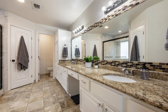 3403 NW Blvd, Georgetown, TX 78628 - bathroom featuring double vanity, a stall shower, and decorative backsplash