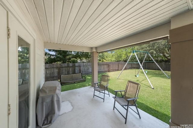 view of patio featuring a fenced backyard and a playground