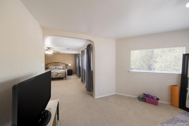 bedroom with baseboards and light carpet
