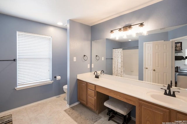 bathroom with toilet, a shower with shower curtain, a sink, and baseboards
