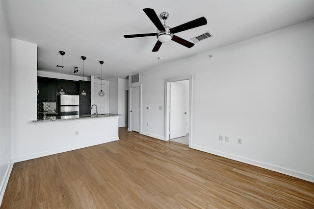 1900 Barton Springs Rd Unit 4023, Austin, TX 78704 - unfurnished living room with wood finished floors and ceiling fan