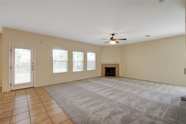 10916 Furrow Hill Dr, Austin, TX 78754 - unfurnished living room featuring ceiling fan, light carpet, a fireplace, and light tile patterned floors