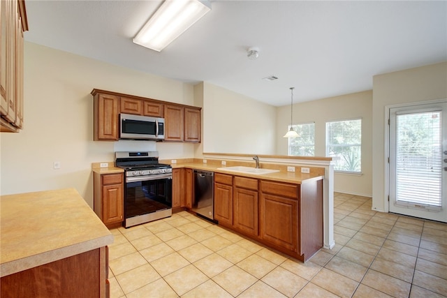 10916 Furrow Hill Dr, Austin, TX 78754 - kitchen featuring appliances with stainless steel finishes, a peninsula, light countertops, and light tile patterned floors