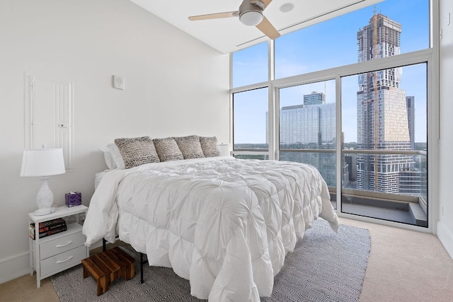 555 E 5th St Unit 2729, Austin, TX 78701 - carpeted bedroom featuring multiple windows, a city view, floor to ceiling windows, and a ceiling fan