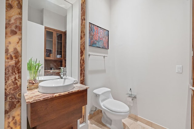 555 E 5th St Unit 2729, Austin, TX 78701 - bathroom featuring toilet, vanity, tile patterned floors, and baseboards