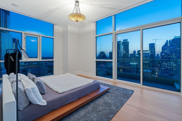 555 E 5th St Unit 2729, Austin, TX 78701 - bedroom featuring wood finished floors, floor to ceiling windows, and a skyline view