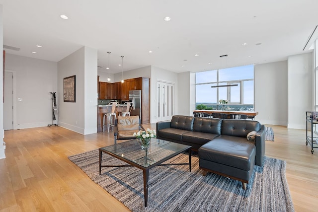 555 E 5th St Unit 2729, Austin, TX 78701 - living room featuring light wood-style floors, recessed lighting, and baseboards