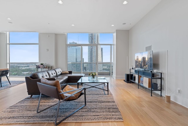 555 E 5th St Unit 2729, Austin, TX 78701 - living area featuring a wall of windows, healthy amount of natural light, wood finished floors, recessed lighting, and baseboards