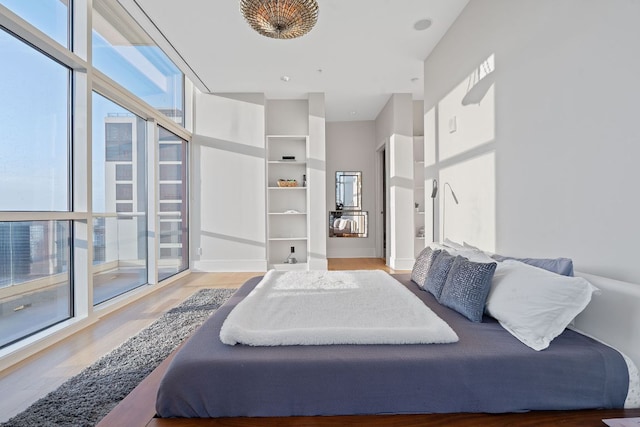 555 E 5th St Unit 2729, Austin, TX 78701 - bedroom featuring multiple windows and wood finished floors