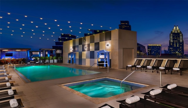 555 E 5th St Unit 2729, Austin, TX 78701 - pool at night featuring a community hot tub, a community pool, and a patio area