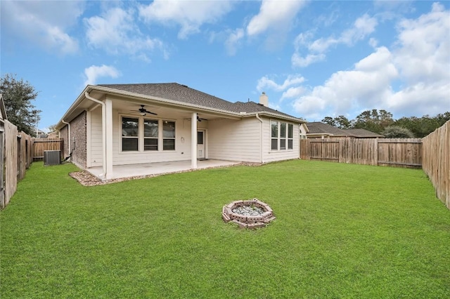 back of property featuring ceiling fan, central air condition unit, a patio, a chimney, and an outdoor fire pit