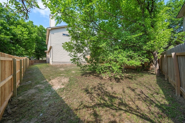 view of yard with a fenced backyard
