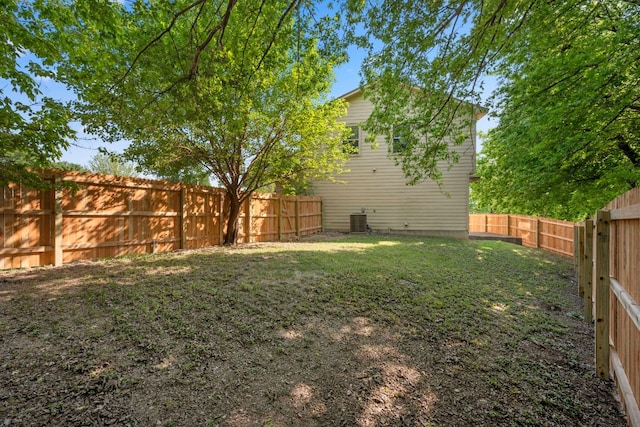 view of yard featuring central AC and a fenced backyard
