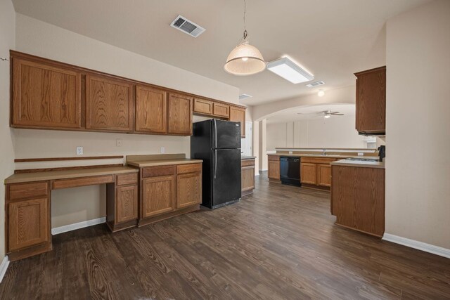 kitchen featuring brown cabinetry, visible vents, dark wood-style flooring, and black appliances