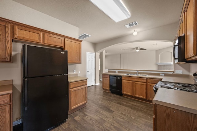 kitchen featuring black appliances, ceiling fan, a sink, and visible vents