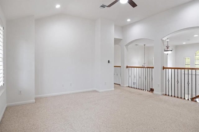unfurnished room with vaulted ceiling, visible vents, carpet, recessed lighting, and ceiling fan