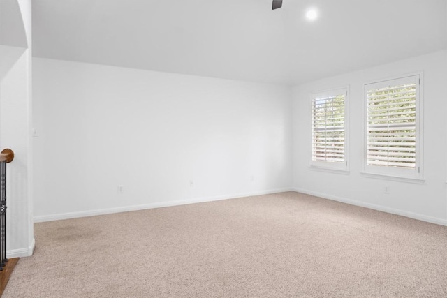 unfurnished living room with baseboards, a ceiling fan, and carpet flooring