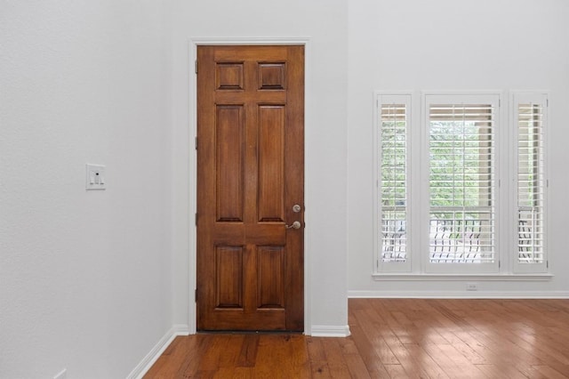 entryway featuring hardwood / wood-style floors and baseboards