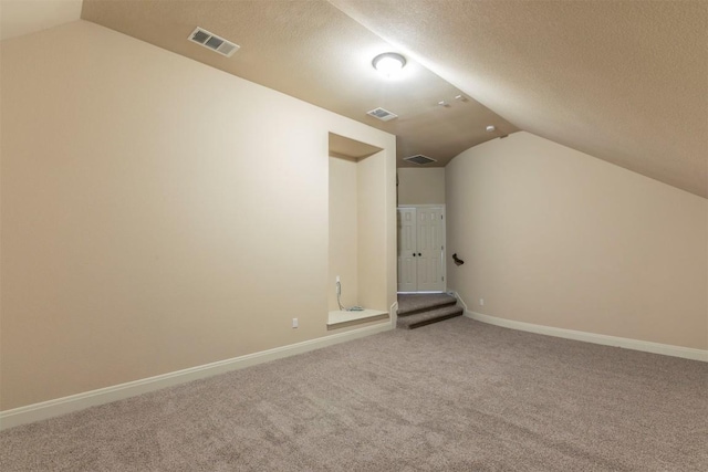 308 Angus Dr, Cedar Park, TX 78613 - bonus room with lofted ceiling, carpet floors, baseboards, and a textured ceiling