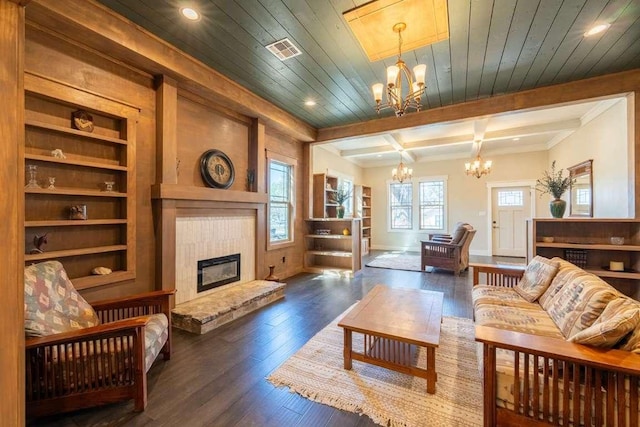 living room with recessed lighting, an inviting chandelier, visible vents, a tiled fireplace, and dark wood-style flooring