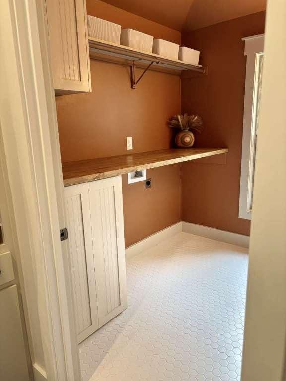 laundry room with electric dryer hookup, cabinet space, and hookup for a washing machine