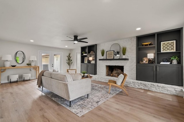 2901 Gabriel View Dr, Georgetown, TX 78628 - living area with wood finished floors, french doors, recessed lighting, ceiling fan, and a fireplace