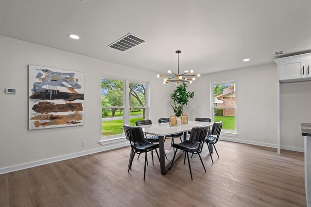 2901 Gabriel View Dr, Georgetown, TX 78628 - dining area with healthy amount of natural light, wood finished floors, a chandelier, and recessed lighting