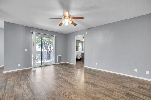 3005 Tyler Ln, Taylor, TX 76574 - spare room featuring a ceiling fan, dark wood-style flooring, and baseboards
