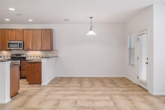 1317 Rimstone Dr, Cedar Park, TX 78613 - kitchen with appliances with stainless steel finishes, brown cabinets, decorative backsplash, recessed lighting, and dark countertops