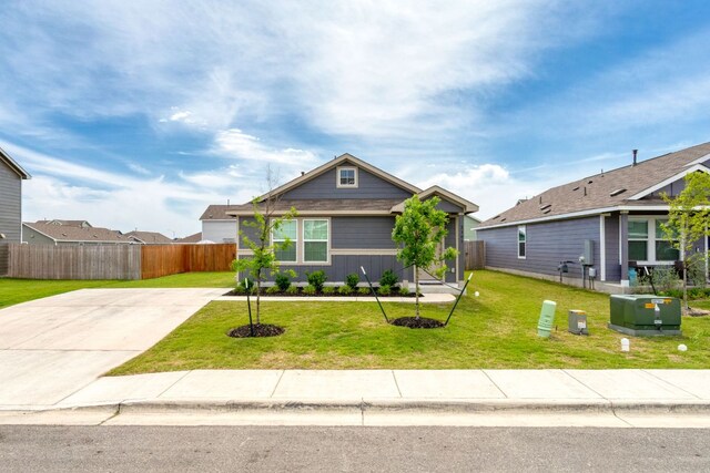 2305 Tornado Aly, Lockhart, TX 78644 - bungalow-style home featuring fence, a front yard, and concrete driveway